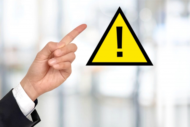 注意マークを指差す