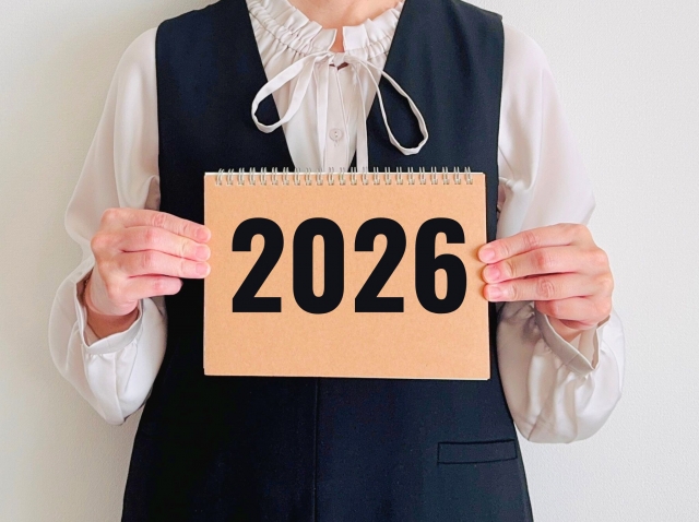 2026と書かれたノートを持つ人